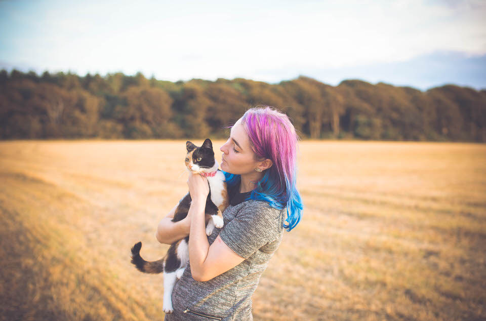 Liverpool Wedding Photographer holding a cat in a field