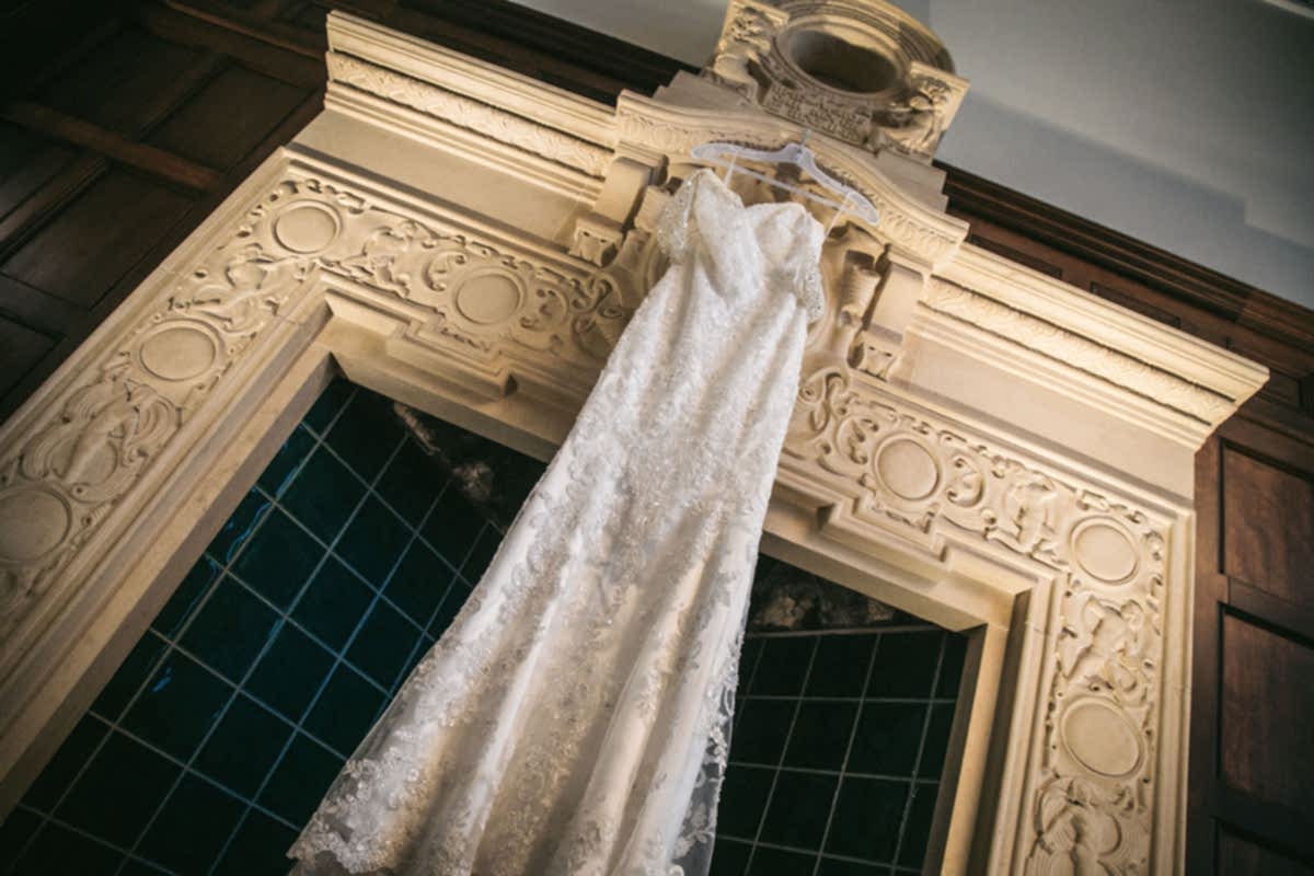 wedding dress hanging on the fireplace