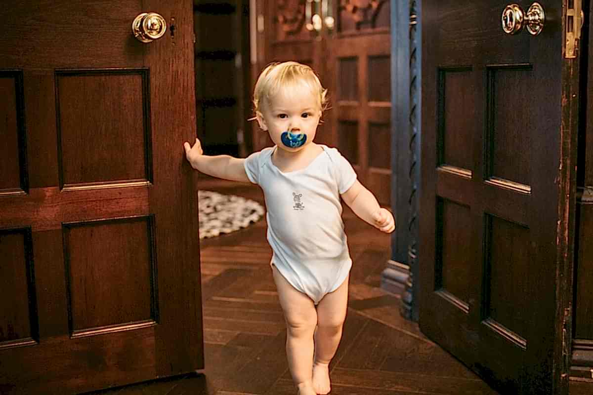 toddler leaning on the door