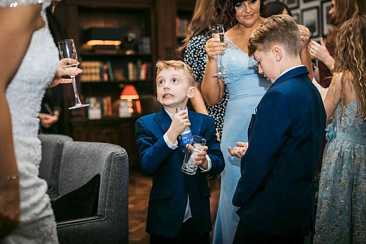 child pulls scared face after spilling a drink