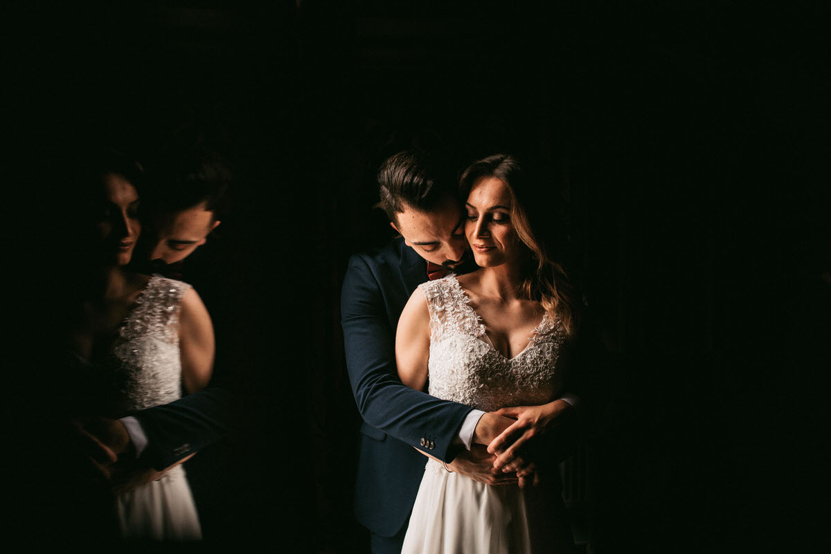 bride and groom's reflection with just black background taken by liverpool wedding phorographer
