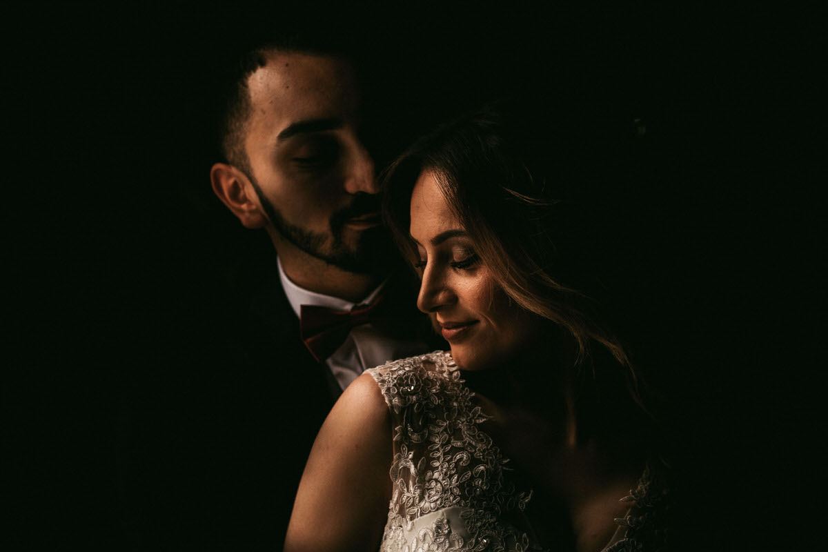 posed with groom hugging bride from behind