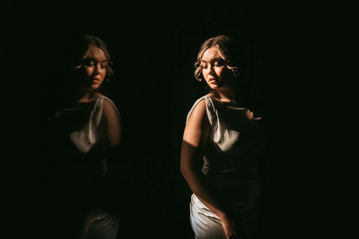 bride's reflection in a dark room taken by liverpool wedding photographer
