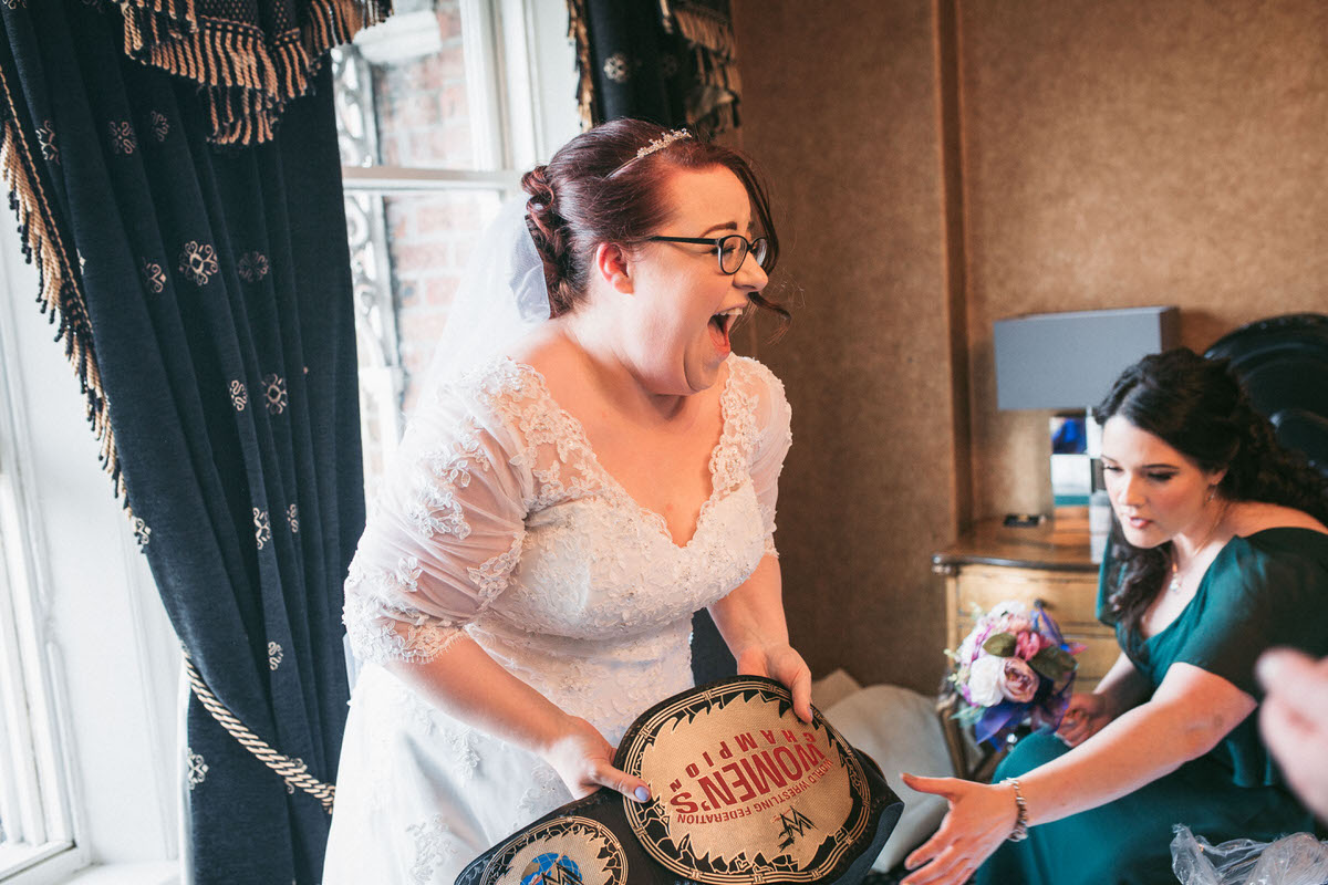 the bride opens a surprising and funny gift from her soon to be husband