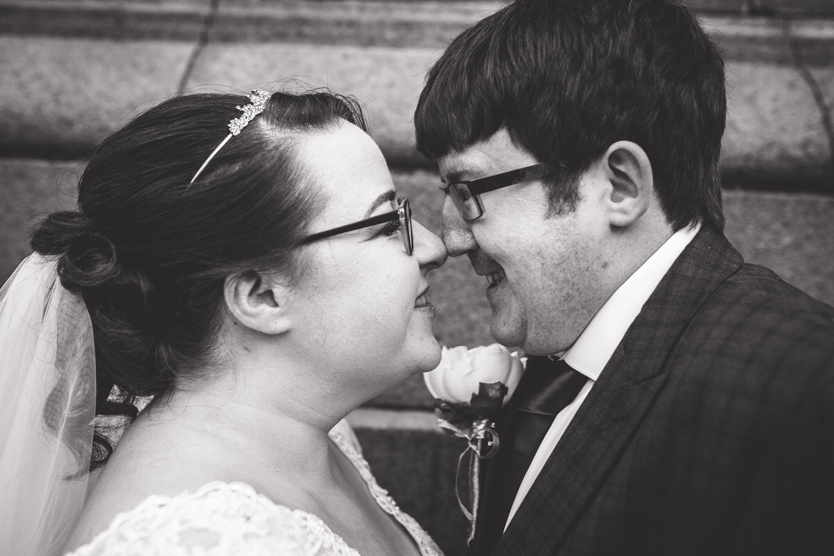 bride and groom getting close and giggling during their couple photos in sefton park