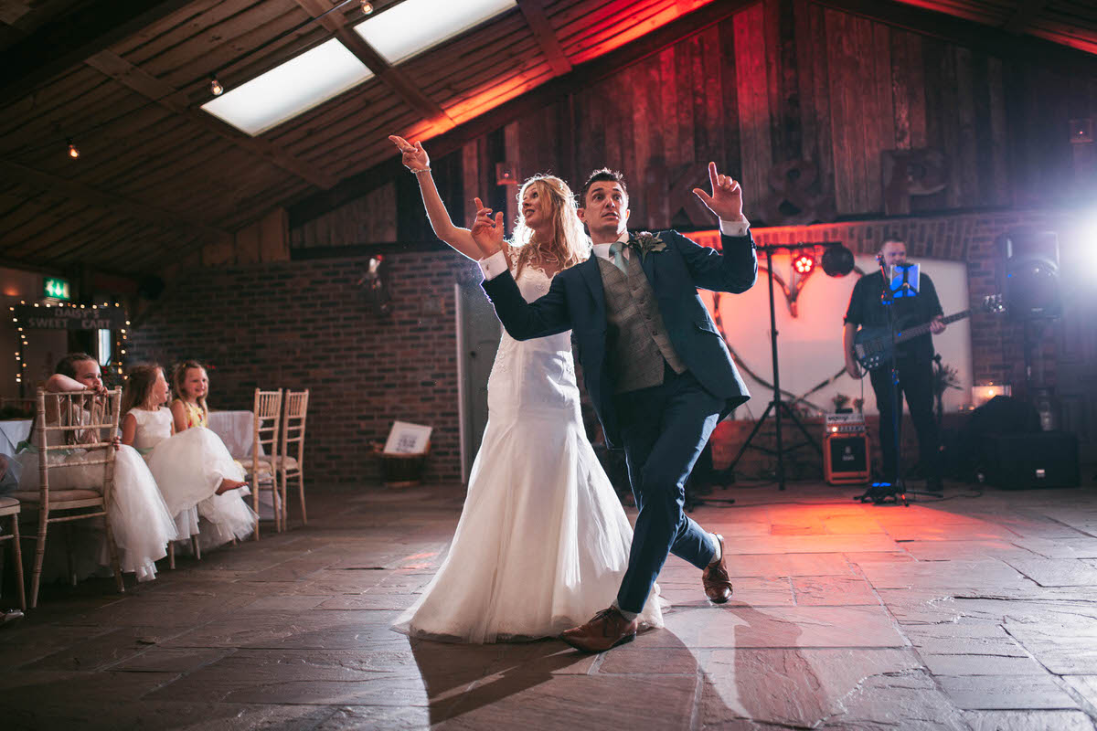 the bride and groom do a cool dance to let's get ready to rumble