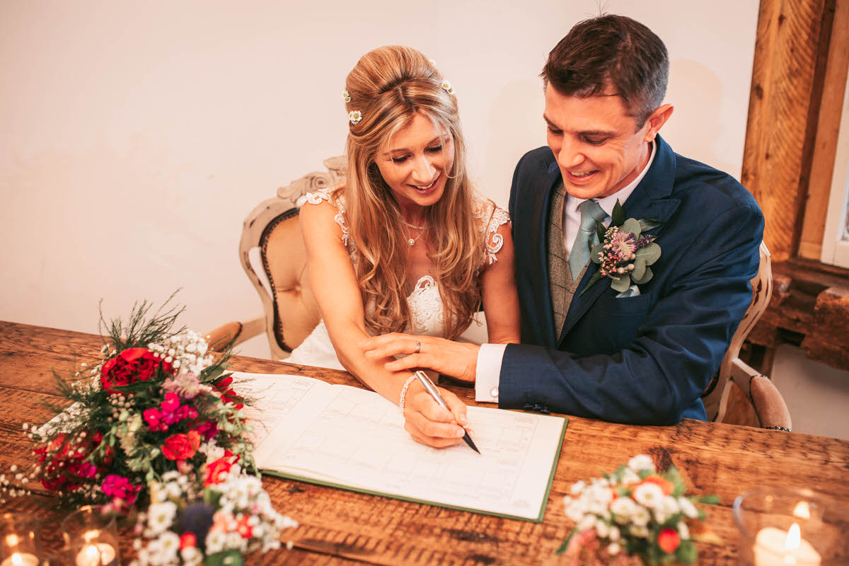 signing the register at owen house wedding barn by liverpool photographer