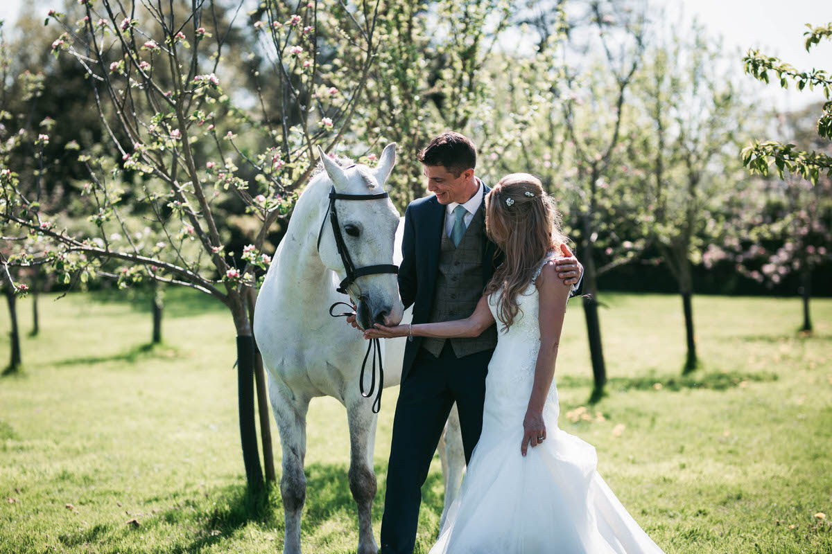 bride and groom with horse at owen house wedding barn taken by liverpool photographer