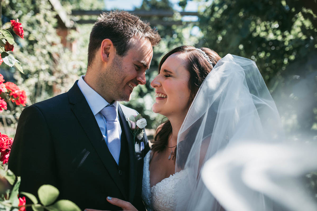 bride laughs during the bride and groom couple photos at willington hall in cheshire