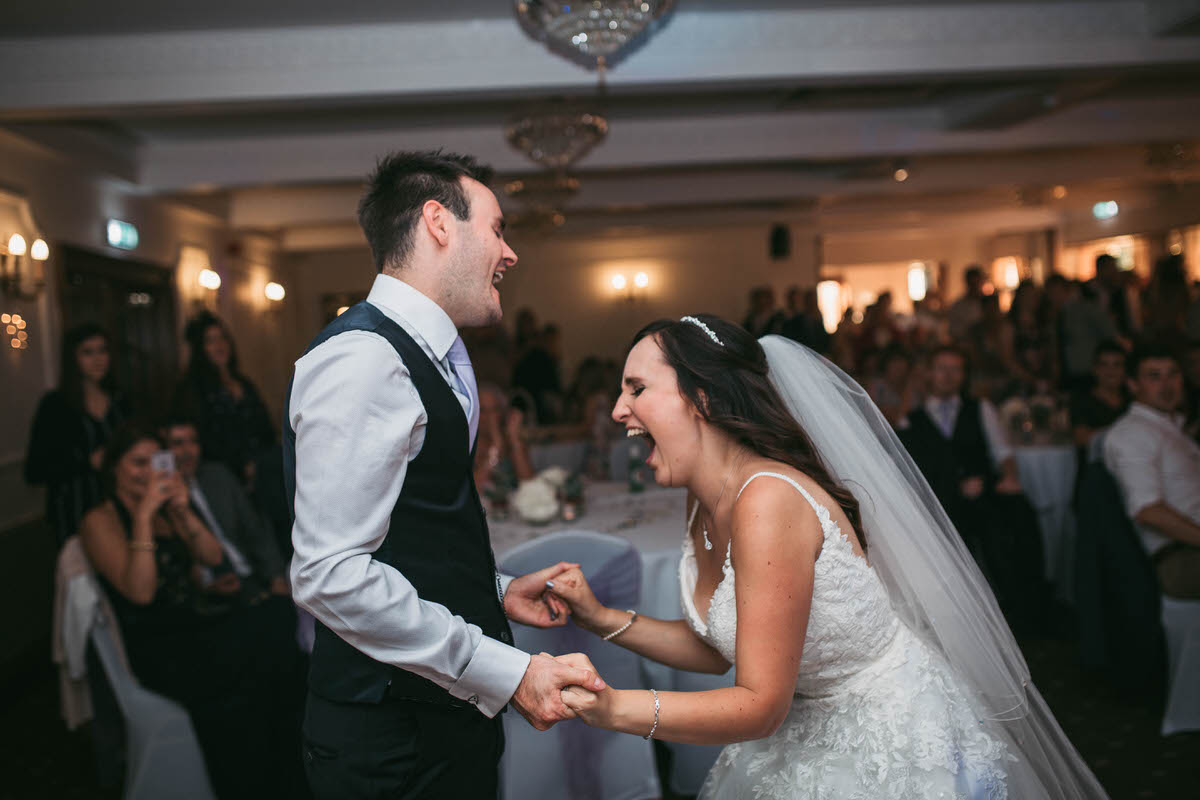 Happy couple rock out to feeling good for their first dance at willington hall cheshire