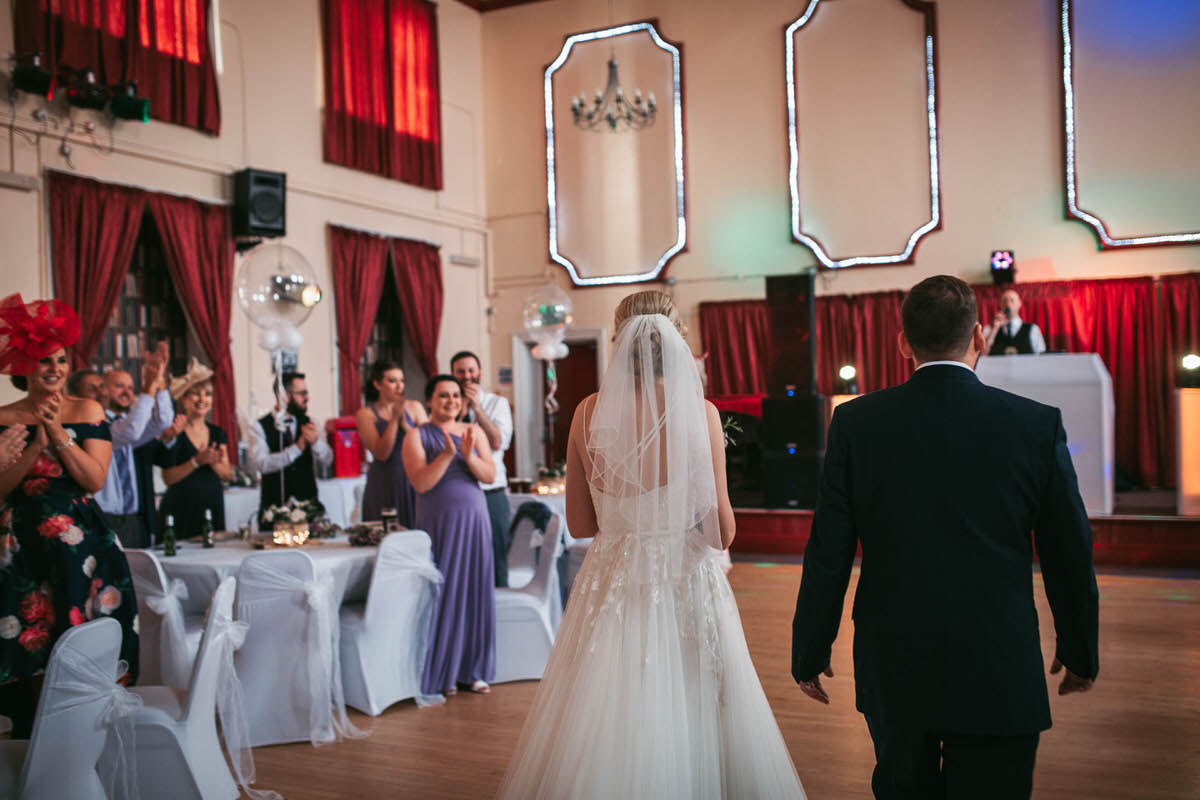 bride and groom enter their wedding reception 