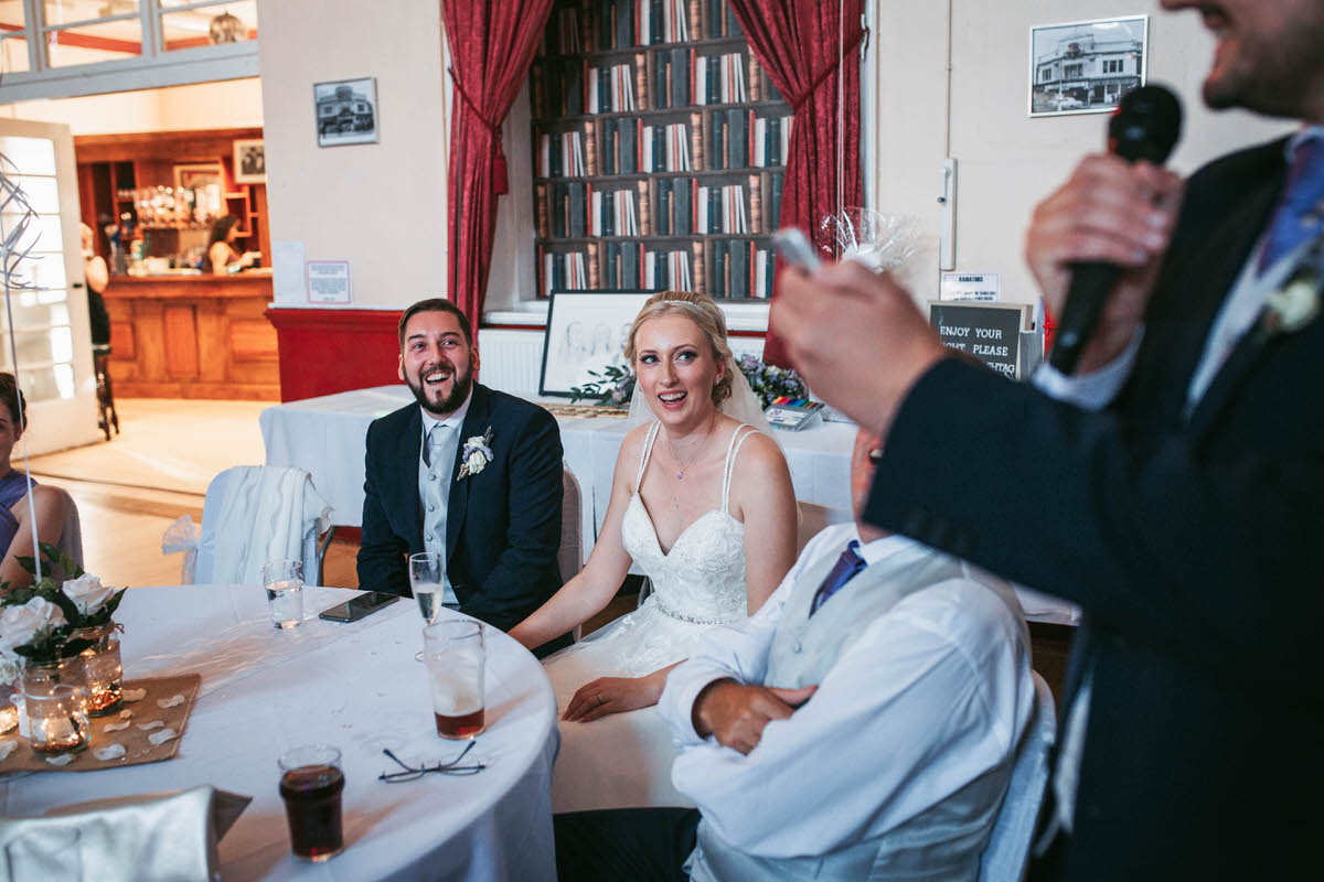 laughing whilst the best man does his speech