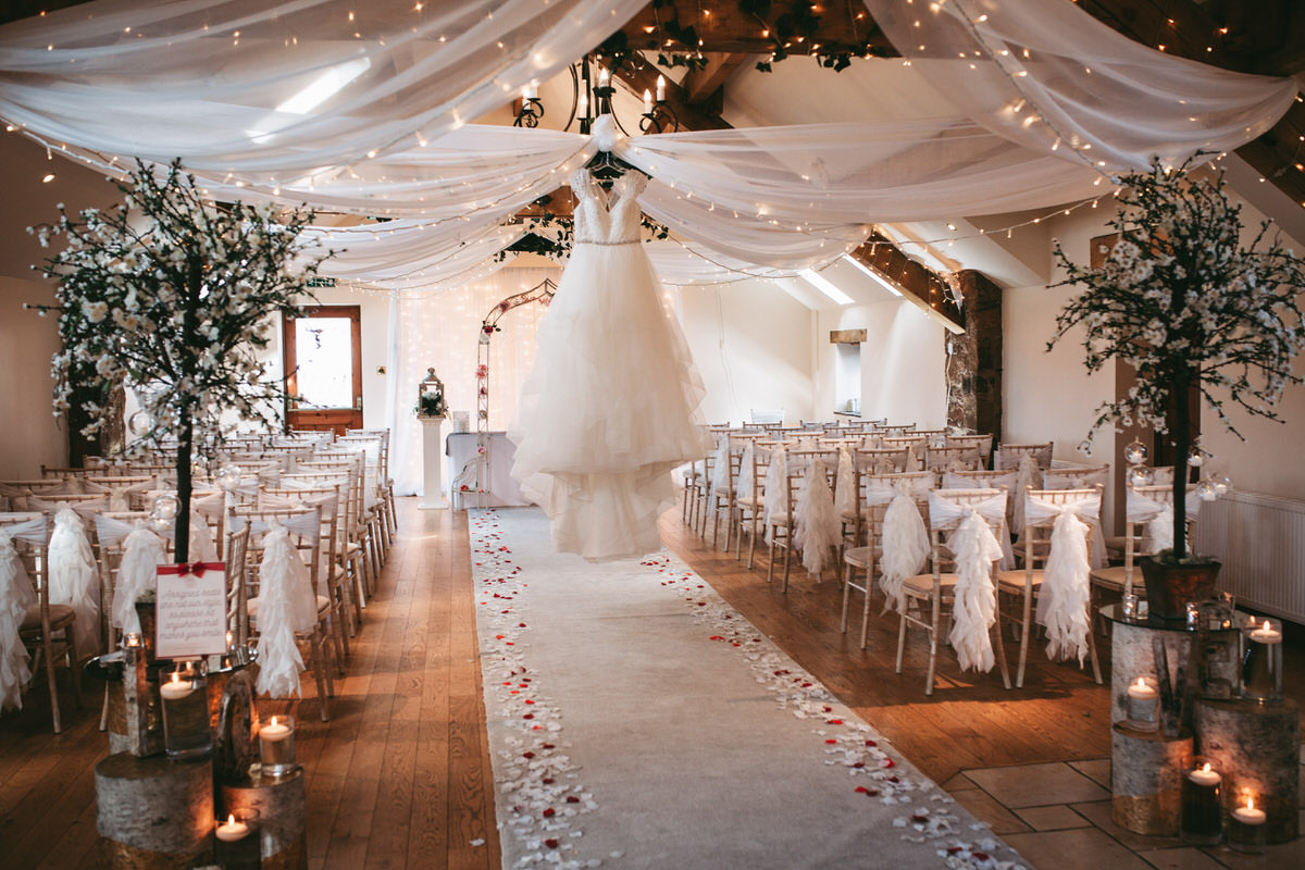 wedding dress hanging in the ceremony room of beeston manor